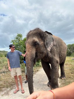 Aaron Brown with an elephant in Southeast Asia